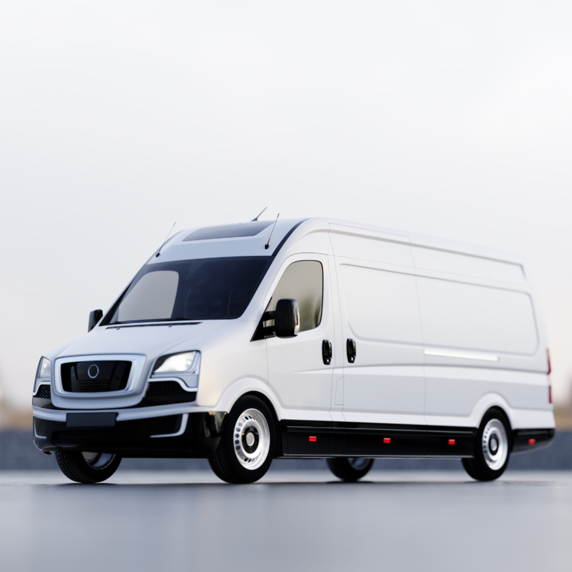 A white cargo van parked on a paved surface, with the front of the van visible and a cloudy sky in the background.