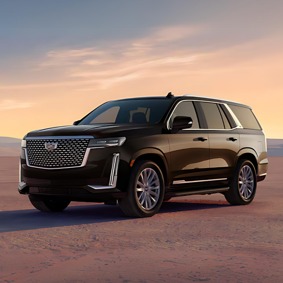 Black SUV parked on a desert landscape during sunset with a cloudy sky.