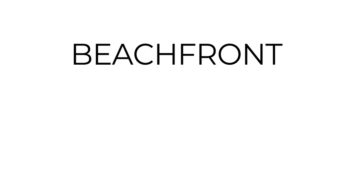 A sign with the words 'Beachfront' in capital letters, indicating oceanfront property or location.