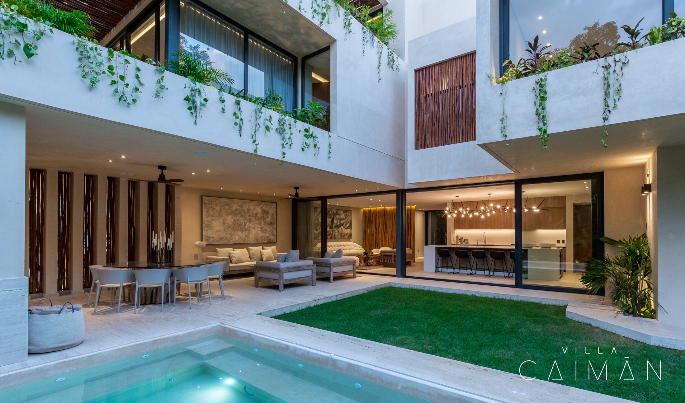 Villa Caimán courtyard with private pool, lawn, and open-air living area, Tulum
