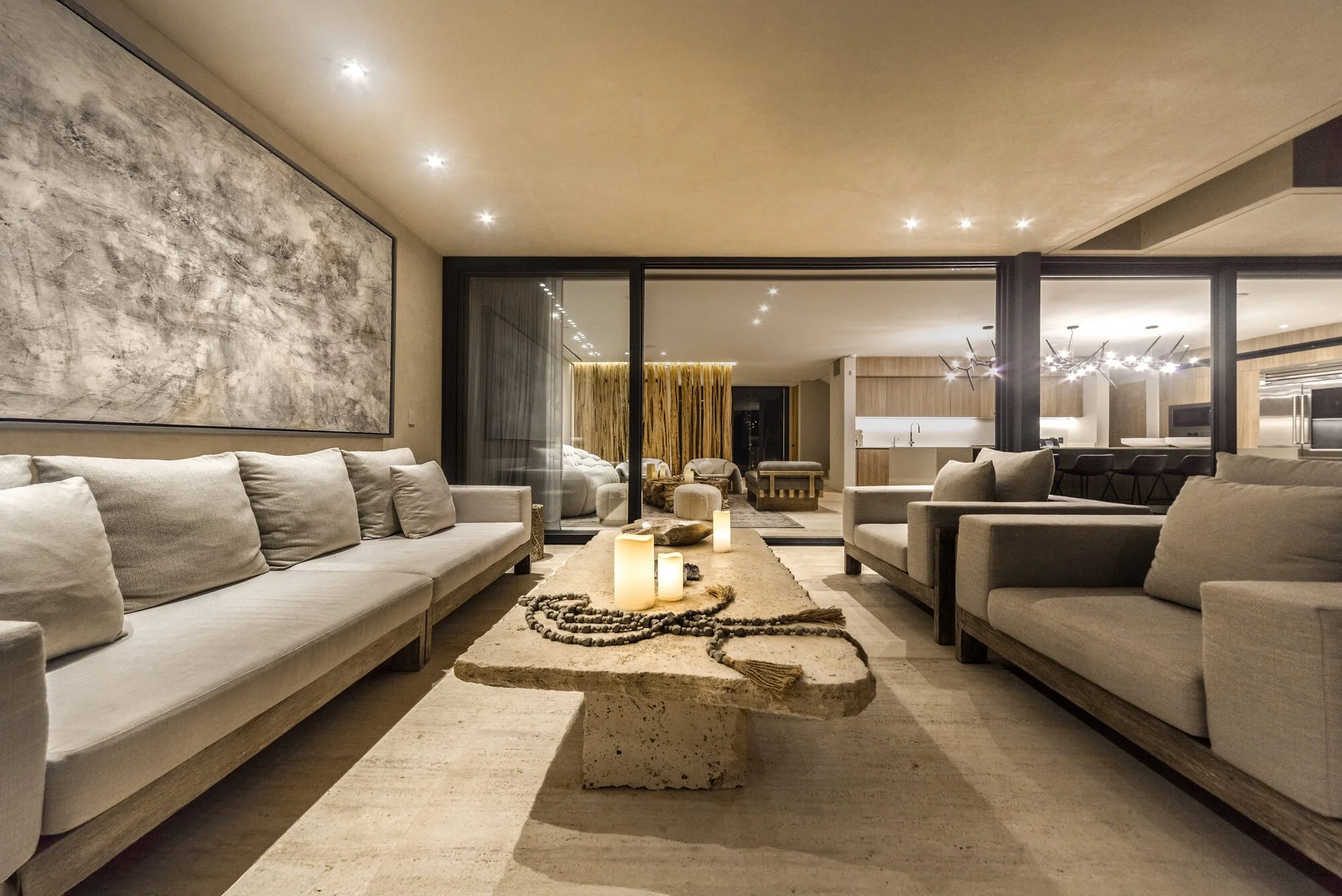 Living room with lounge seating and jungle views at Villa Caimán, Tulum