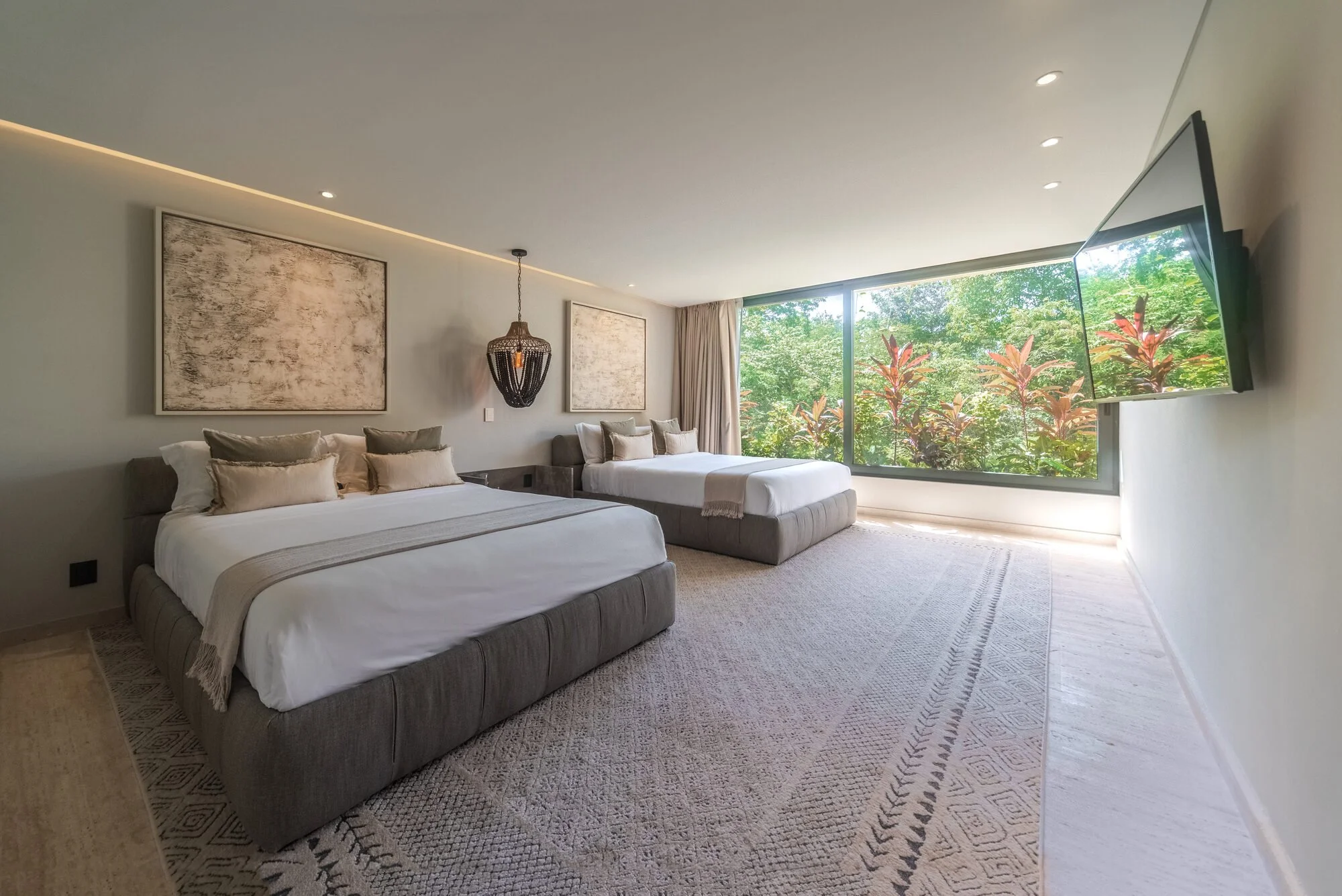 En-suite bedroom with garden views at Villa Caimán, Tulum