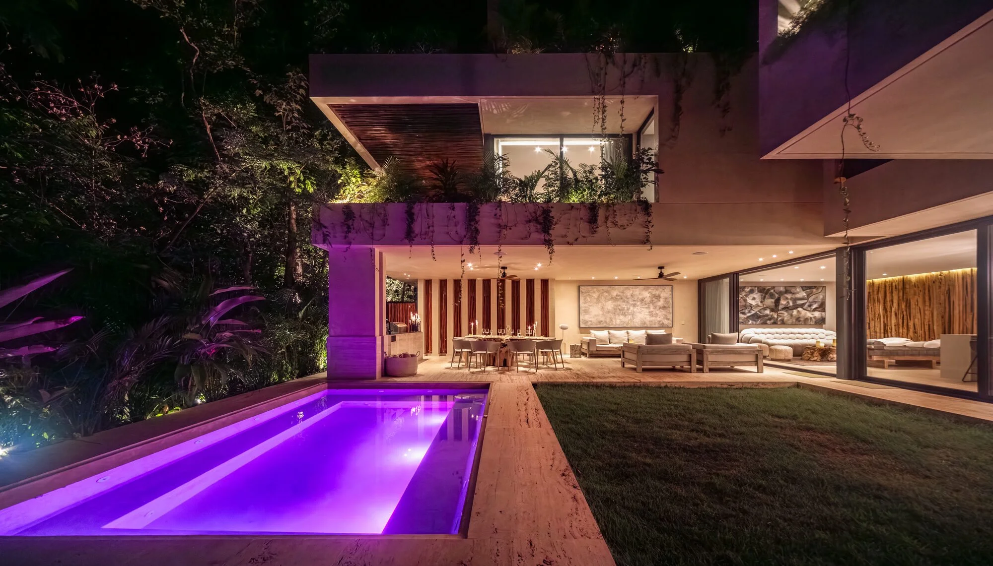 Private pool illuminated at night at Villa Caimán, Tulum