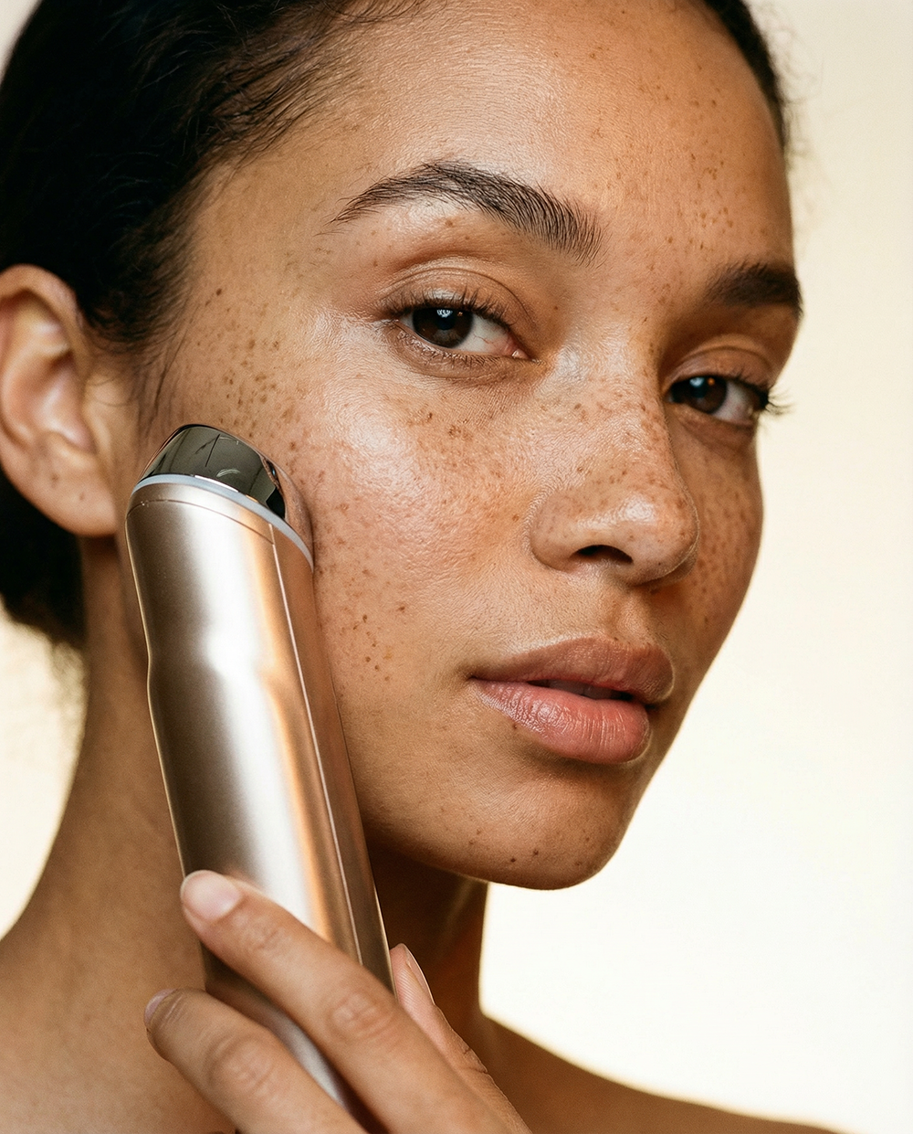 Model holding the Skinwave, multi-function korean beauty device