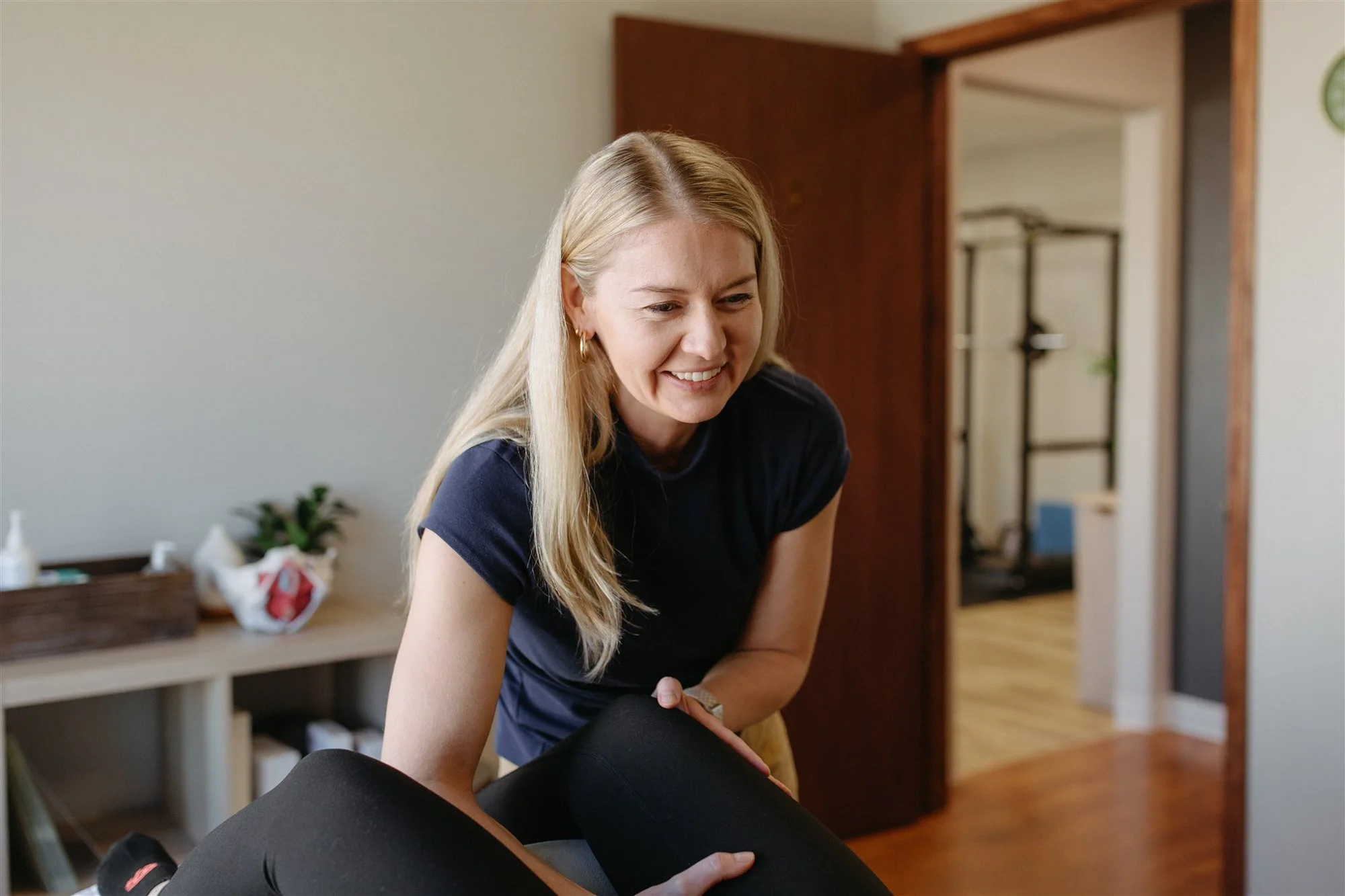 Pelvic therapy session focused on pelvic pain treatment showing a therapist smiling at patient