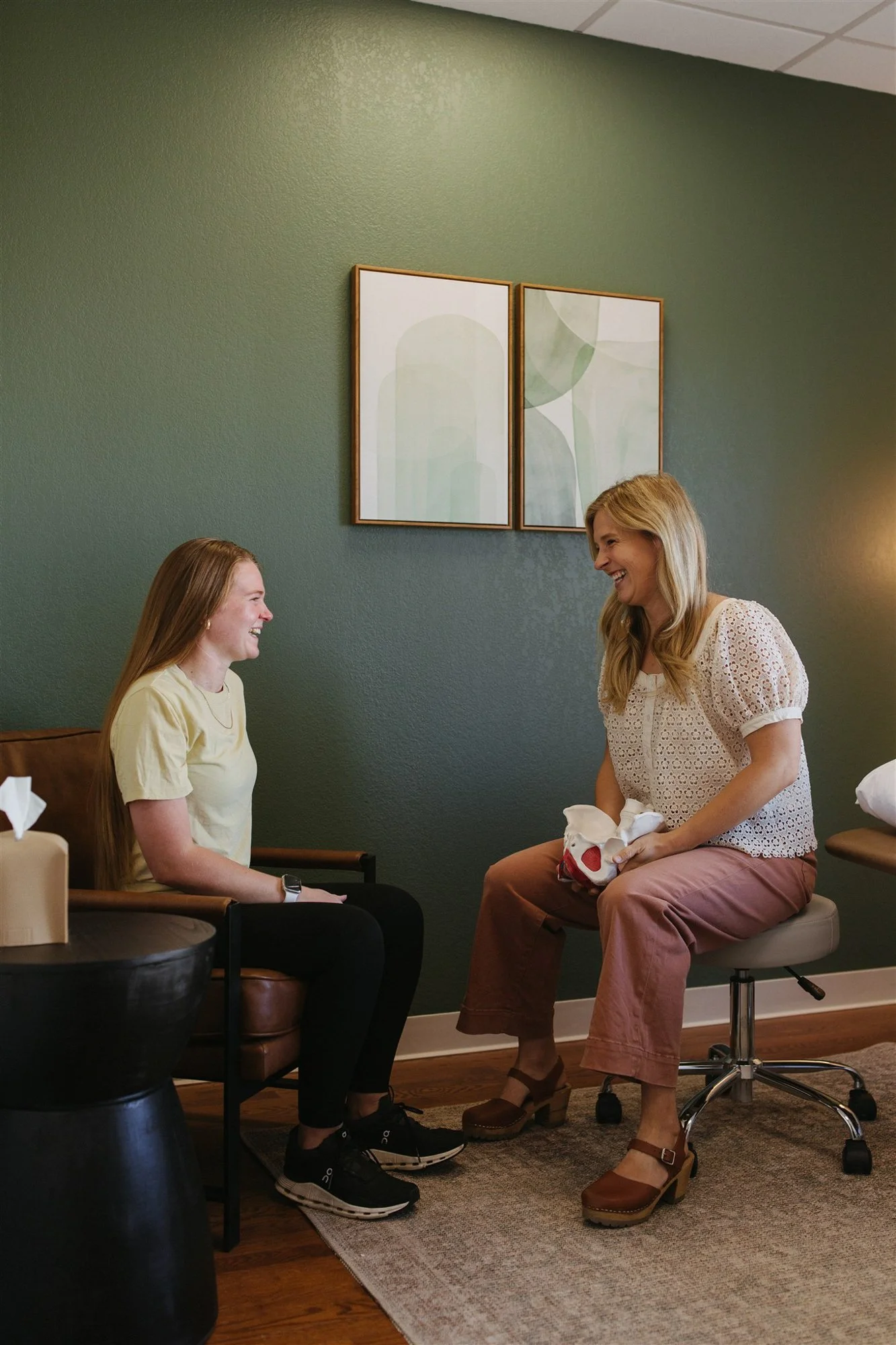 Pelvic floor physical therapy session with pelvic therapist talking to a patient