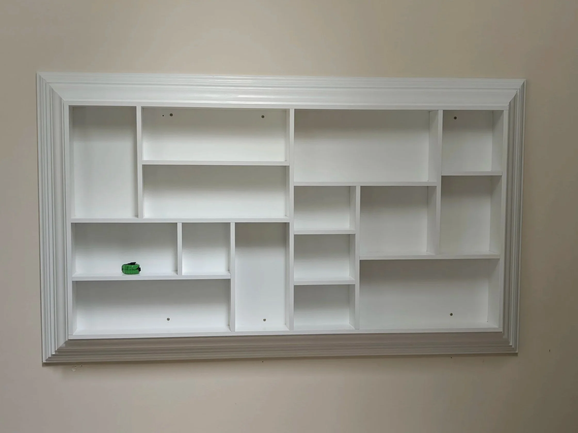 Staggered shelf, wall mounted curio cabinet