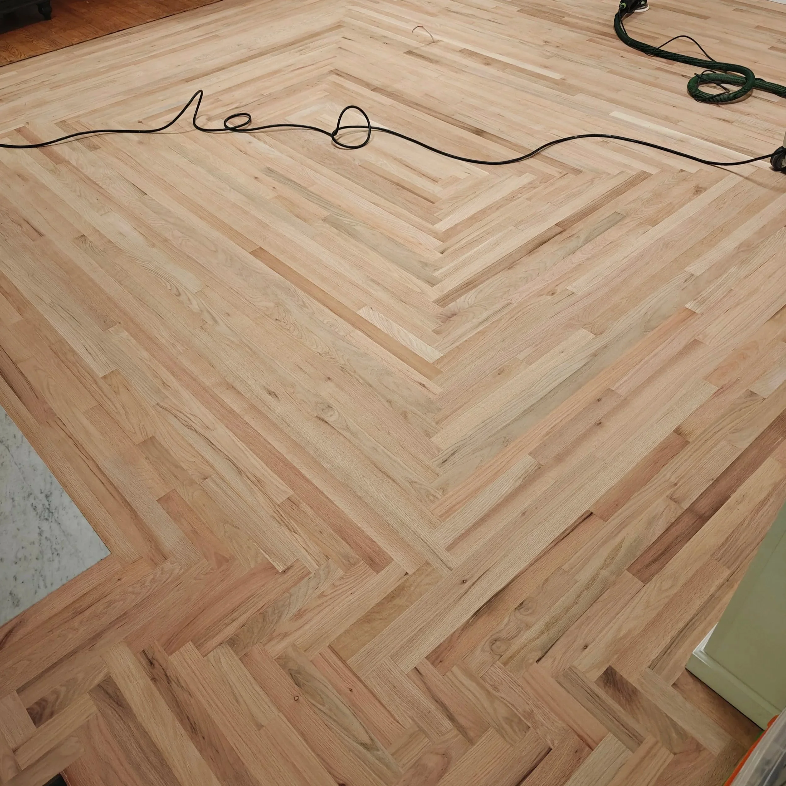 Close-up of a wooden hardwood floor with a herringbone pattern