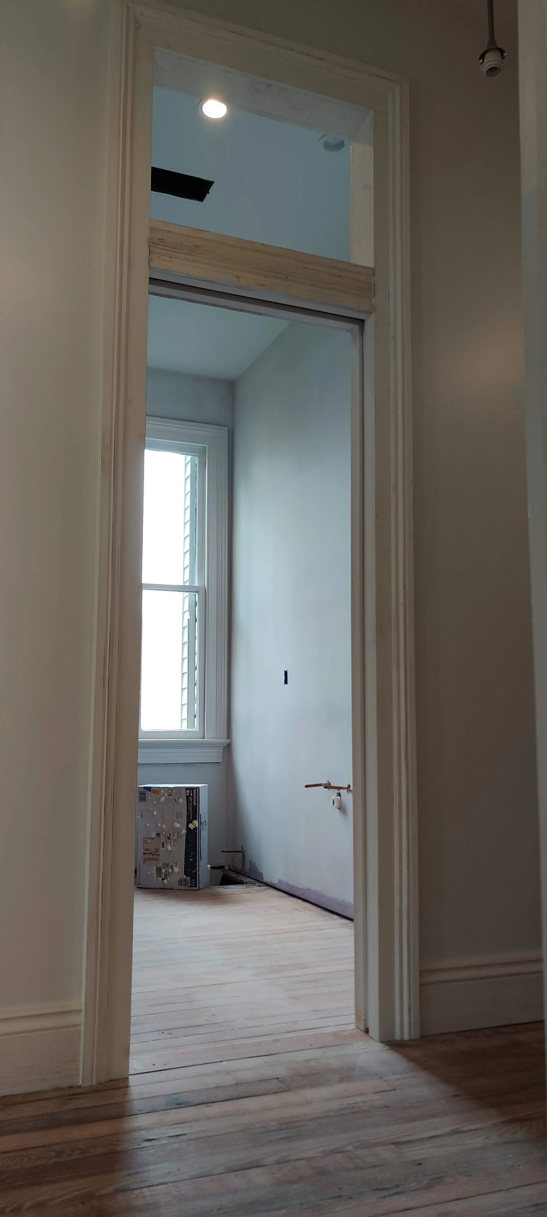 custom door casing with pocket door and transom