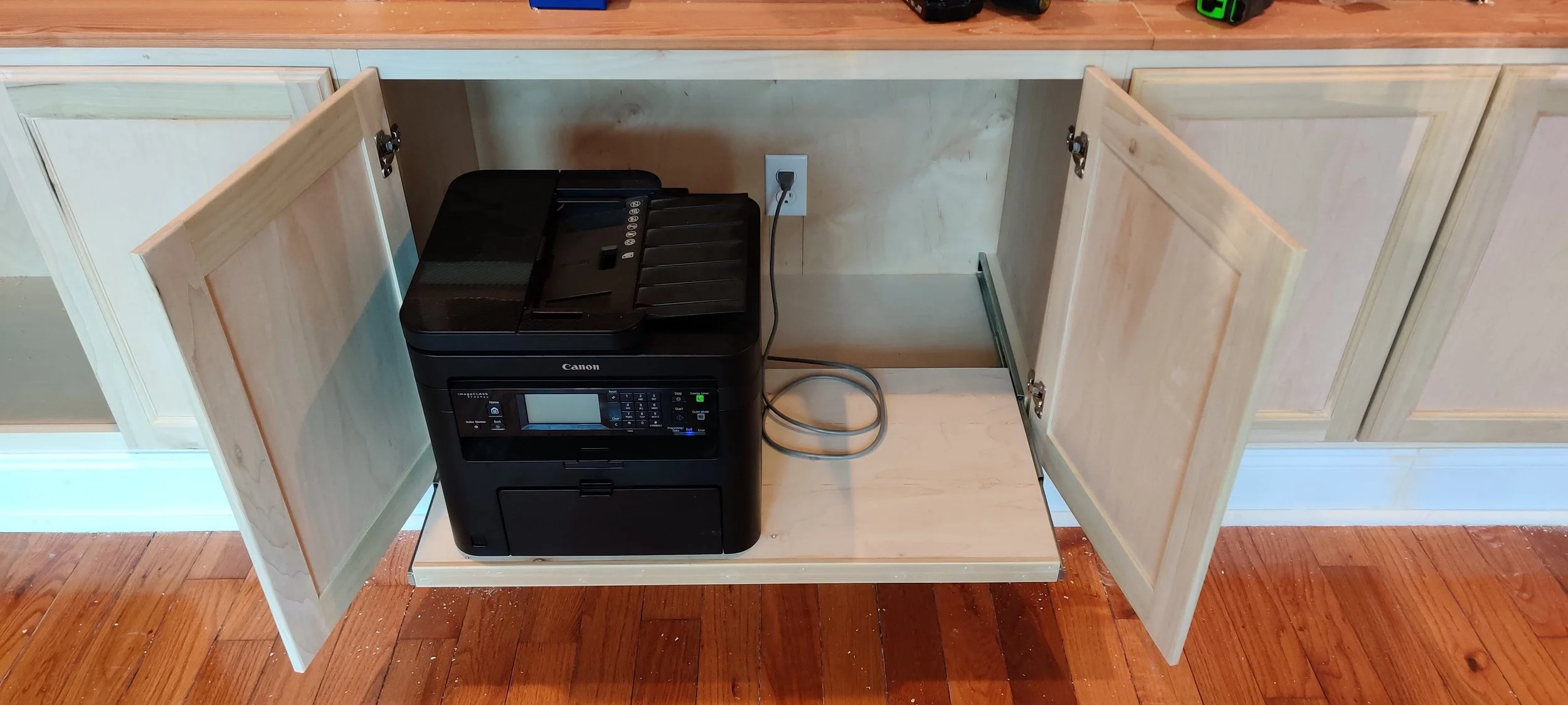 Built-in home office with hidden pull out tray for printer.