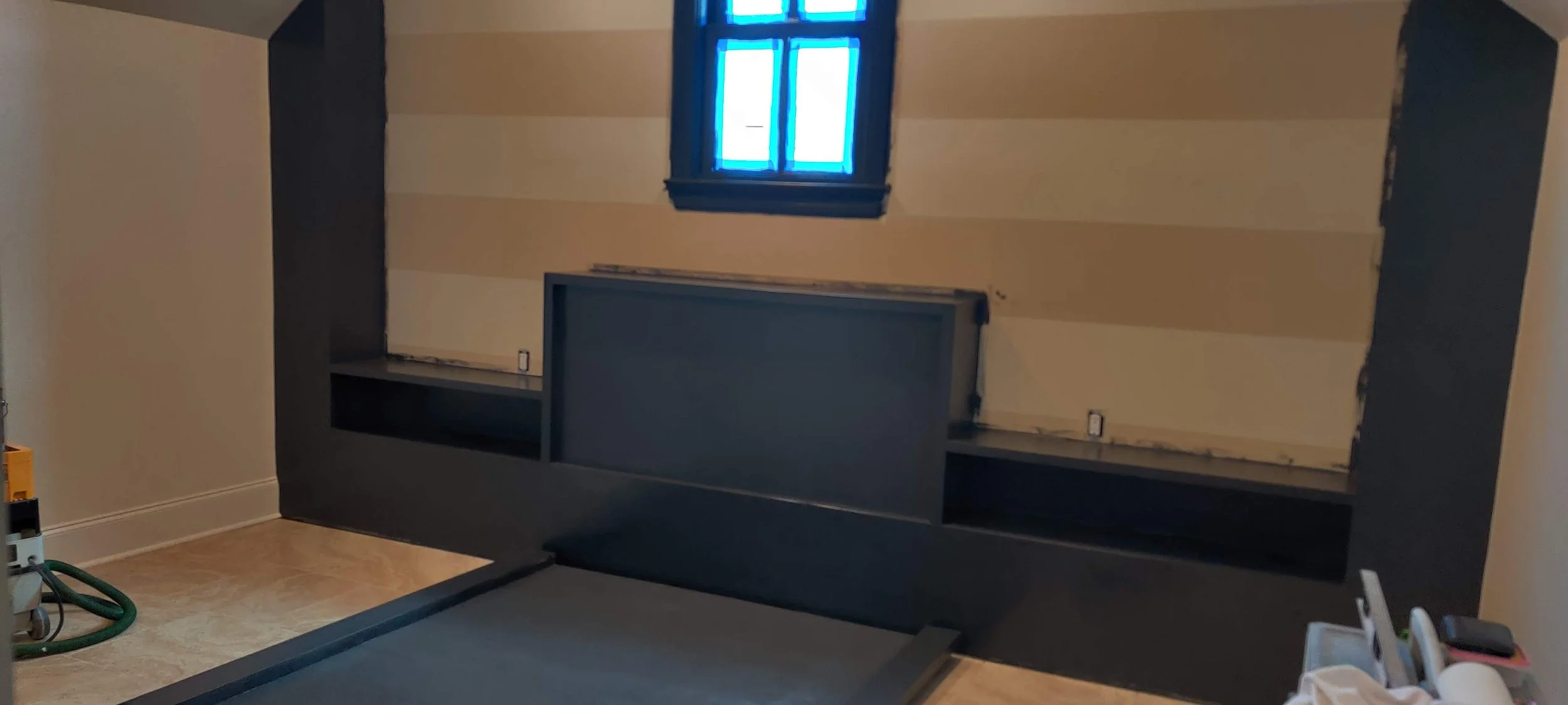 Room under renovation with builtin platform bed and built-in night stands