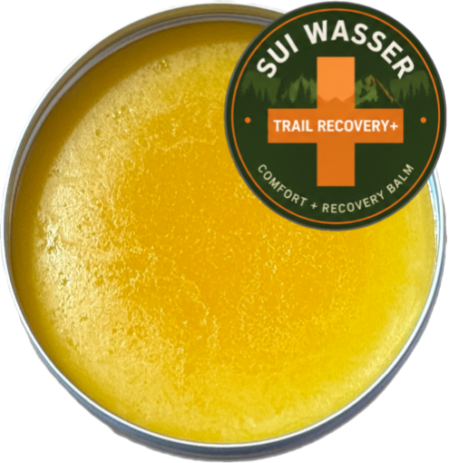 Trail Recovery+ Balm, a golden yellow balm, plus Logo