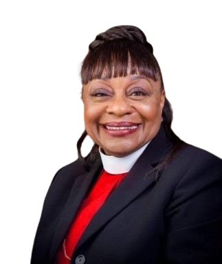 A smiling woman with short hair styled in bangs and an updo, wearing a dark blazer over a red top, against a background with red, gray, green, and blue sections.