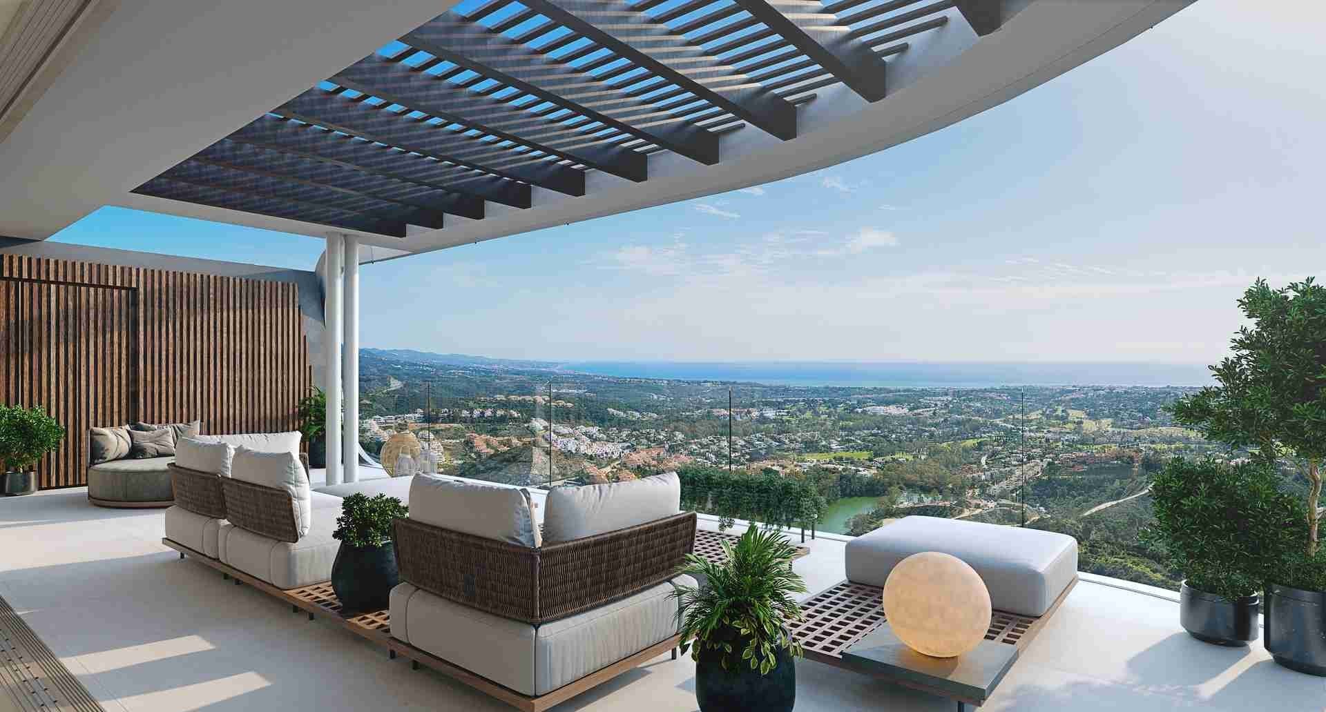 Outdoor terrace at Enebros Real de La Quinta with white seating, glass railing, potted plants, and panoramic hills, water, and city views