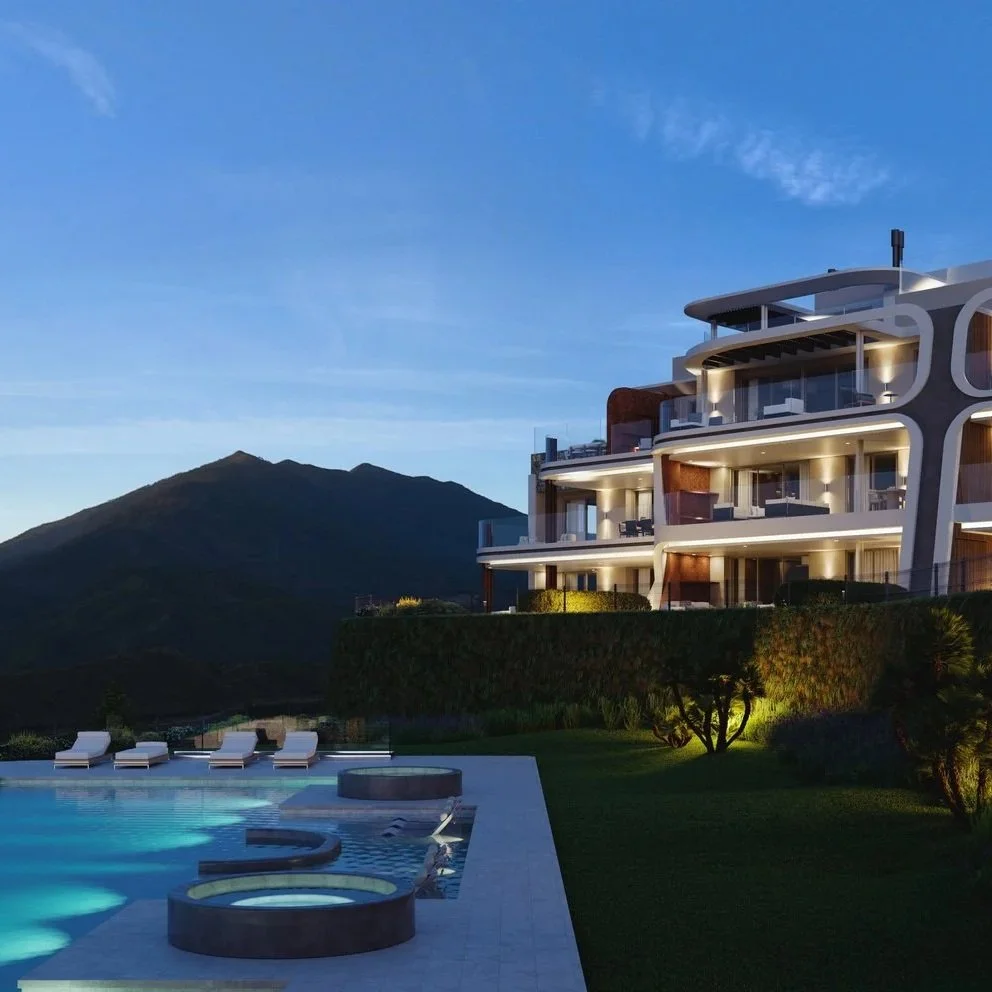 Luxury resort swimming pool in Marbella with mountain views at dusk