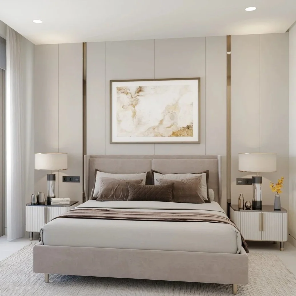 Neutral-toned bedroom in La Quinta apartment with bed, pillows, lamps, and decorative wall art