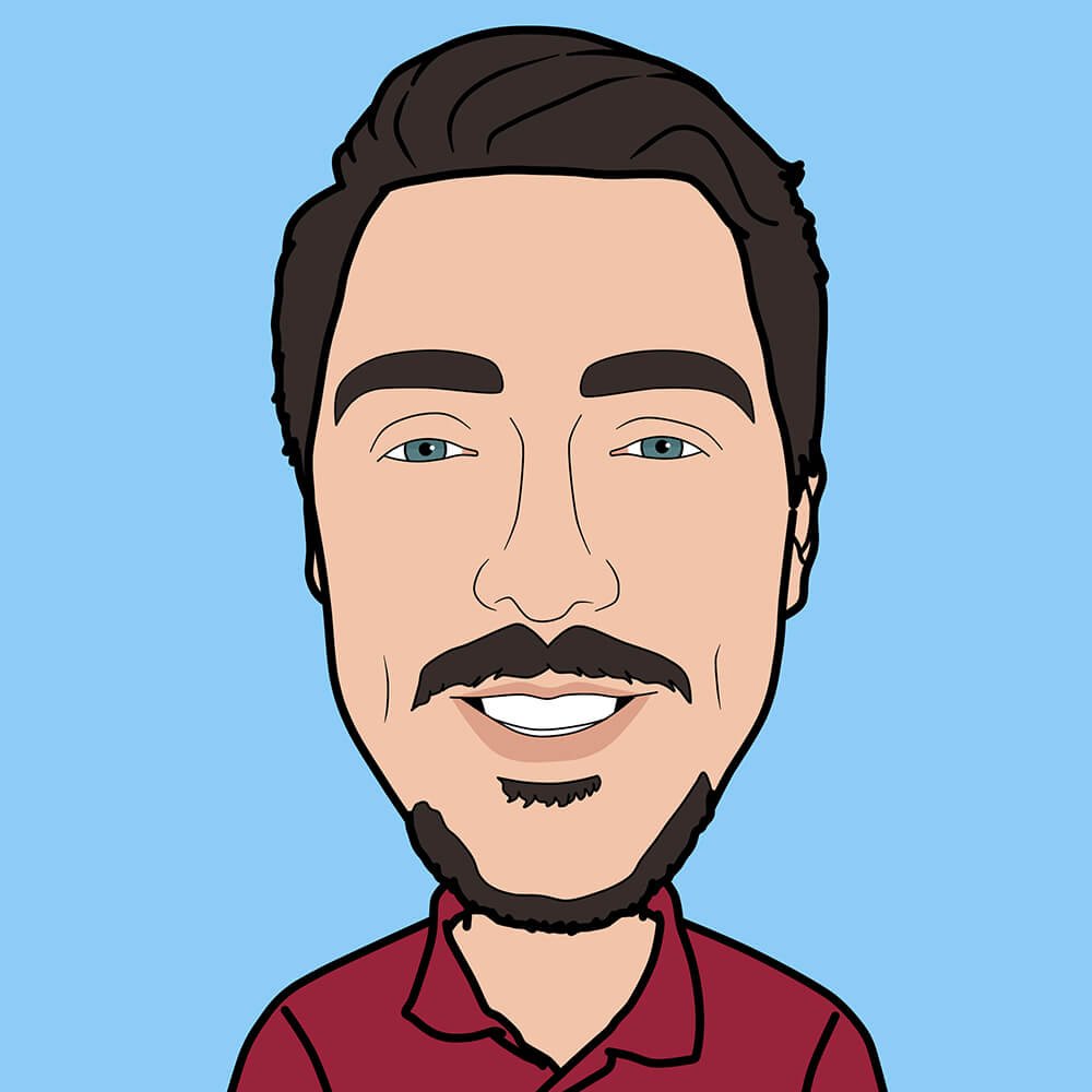 Cartoon portrait of a man with dark hair, blue eyes, a mustache, a goatee, and wearing a red shirt, smiling against a light blue background.