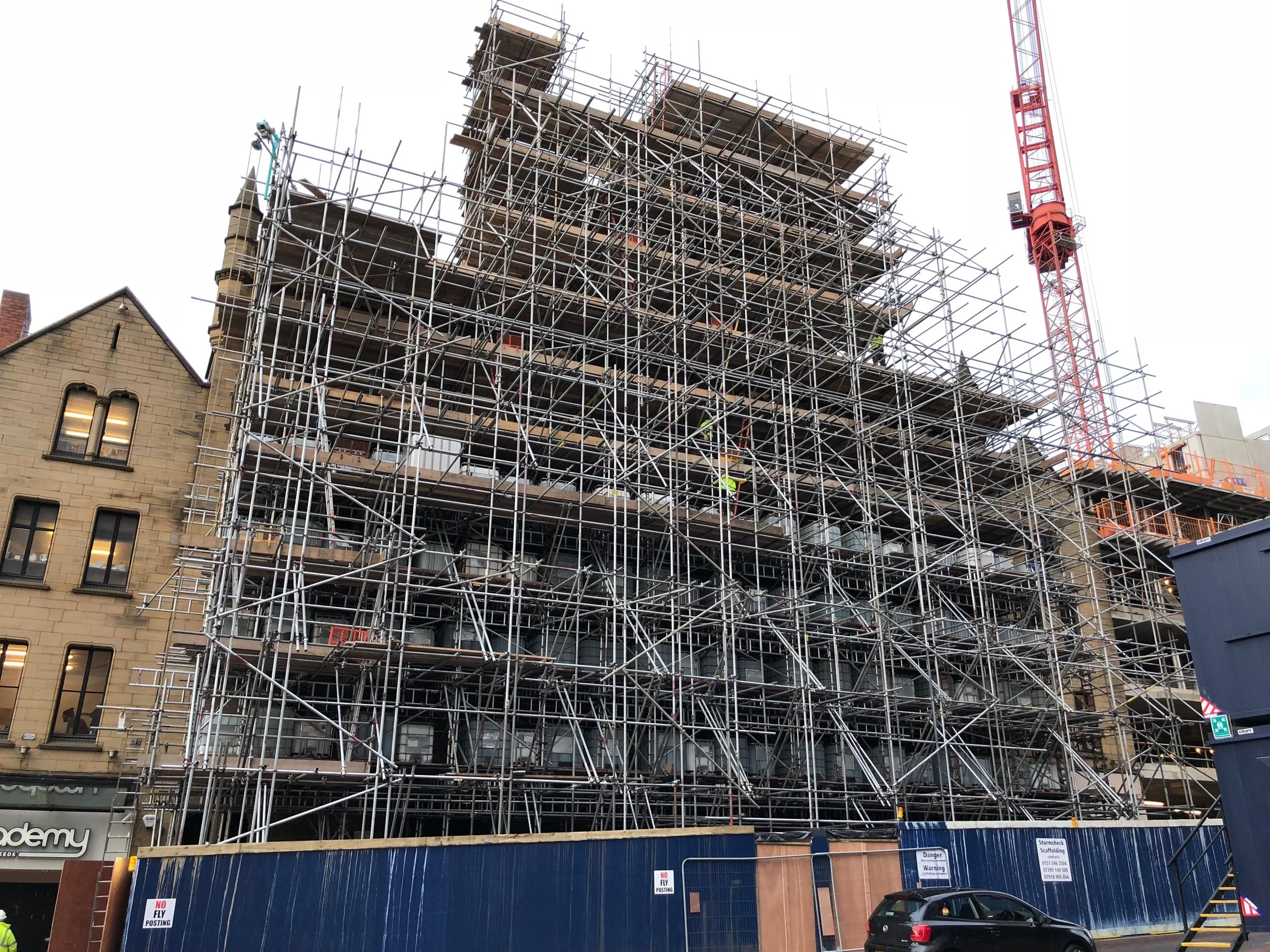 Facade shore made form scaffolding shoring up gable of building