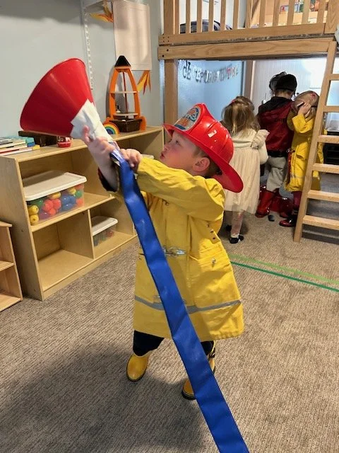 A kid dressed up as a firefighter at Beaumont Children's Center bilingual Chinese preschool in Portland, Oregon