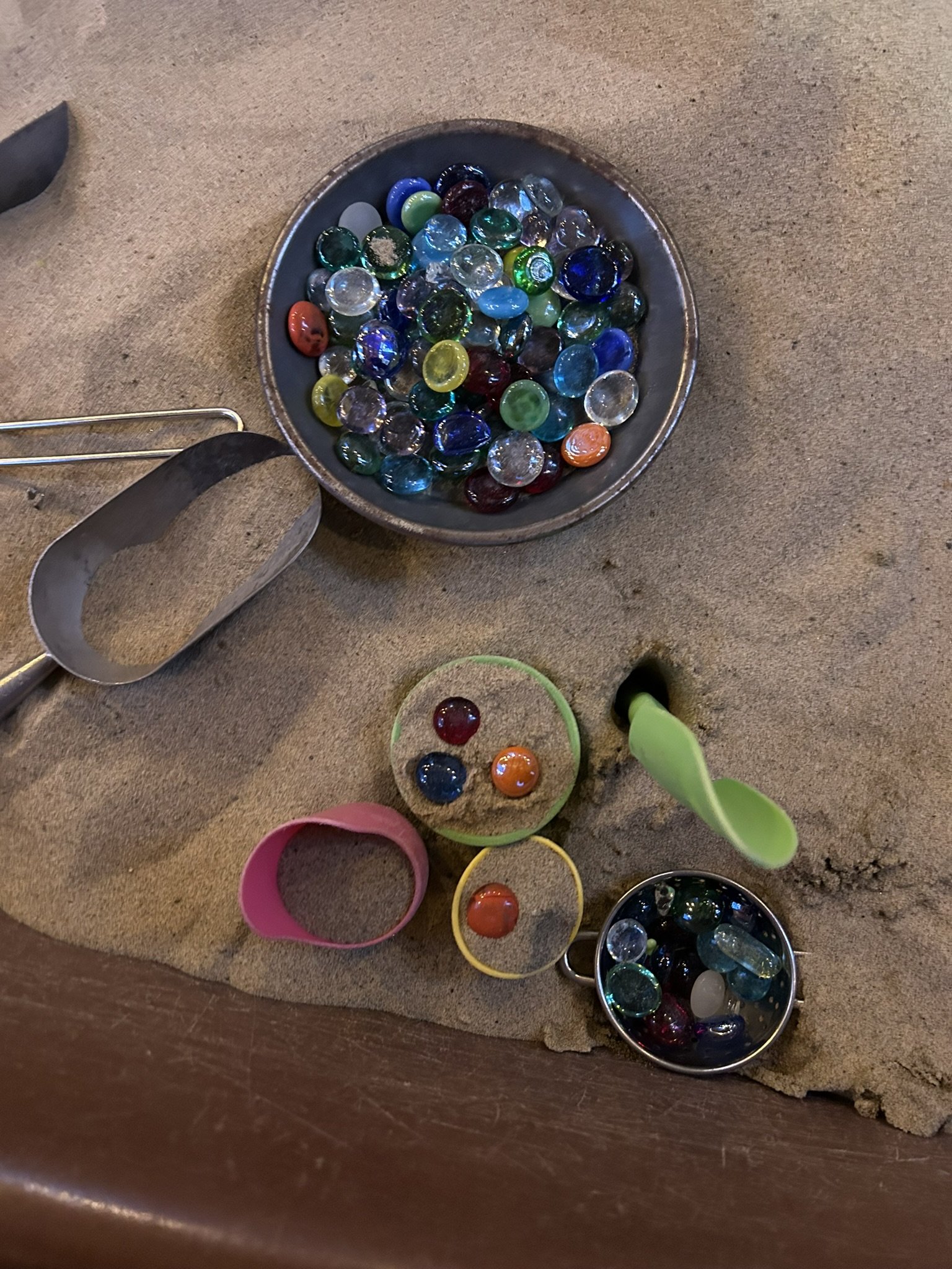 Marbles in the sandbox at Beaumont Children's Center bilingual Chinese preschool in Portland, Oregon