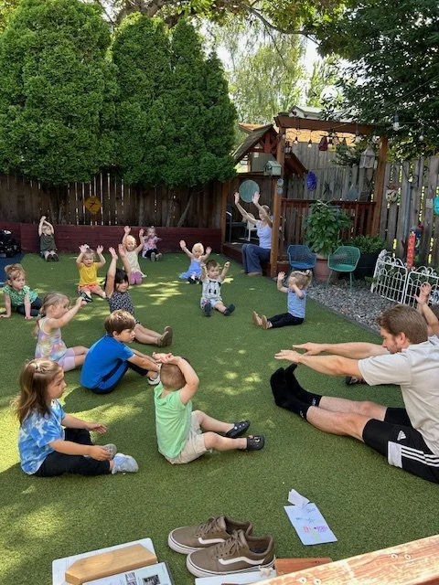 Kids and teachers doing yoga at Beaumont Children's Center bilingual Chinese preschool in Portland, Oregon