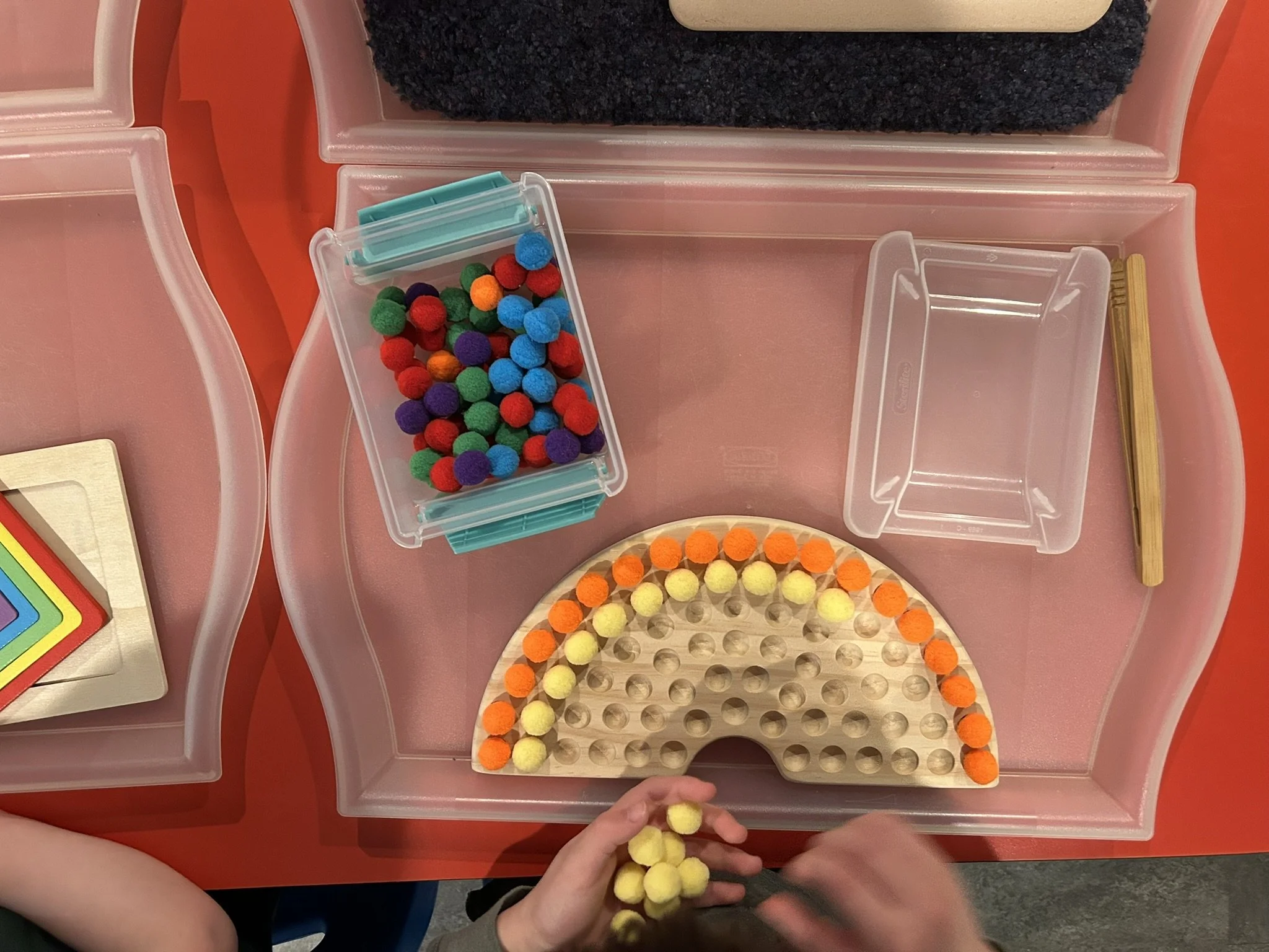 Colorful pompoms in a rainbow at Beaumont Children's Center bilingual Chinese preschool in Portland, Oregon