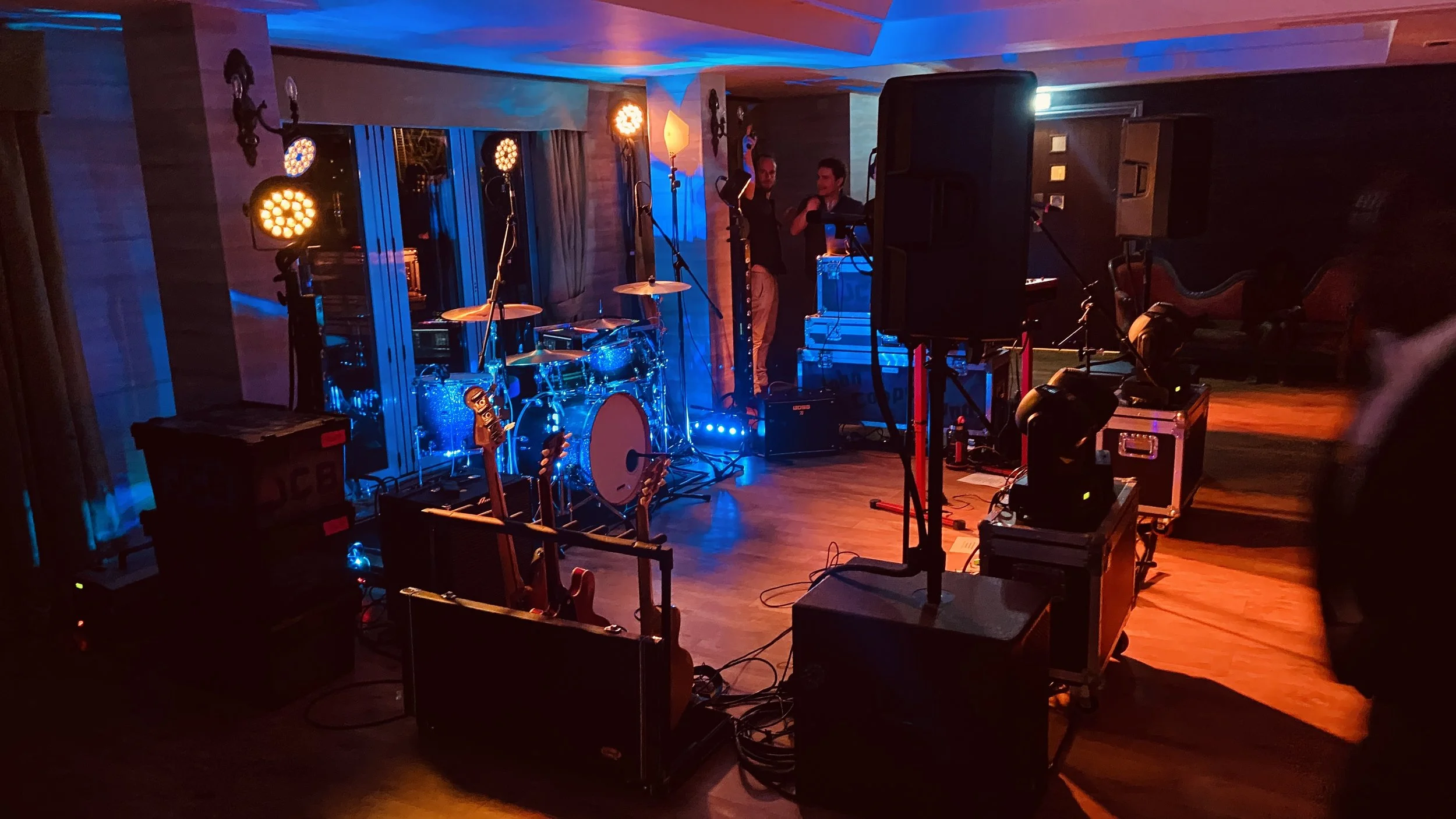 Empty stage with musical instruments and stage lighting, ready for a performance.