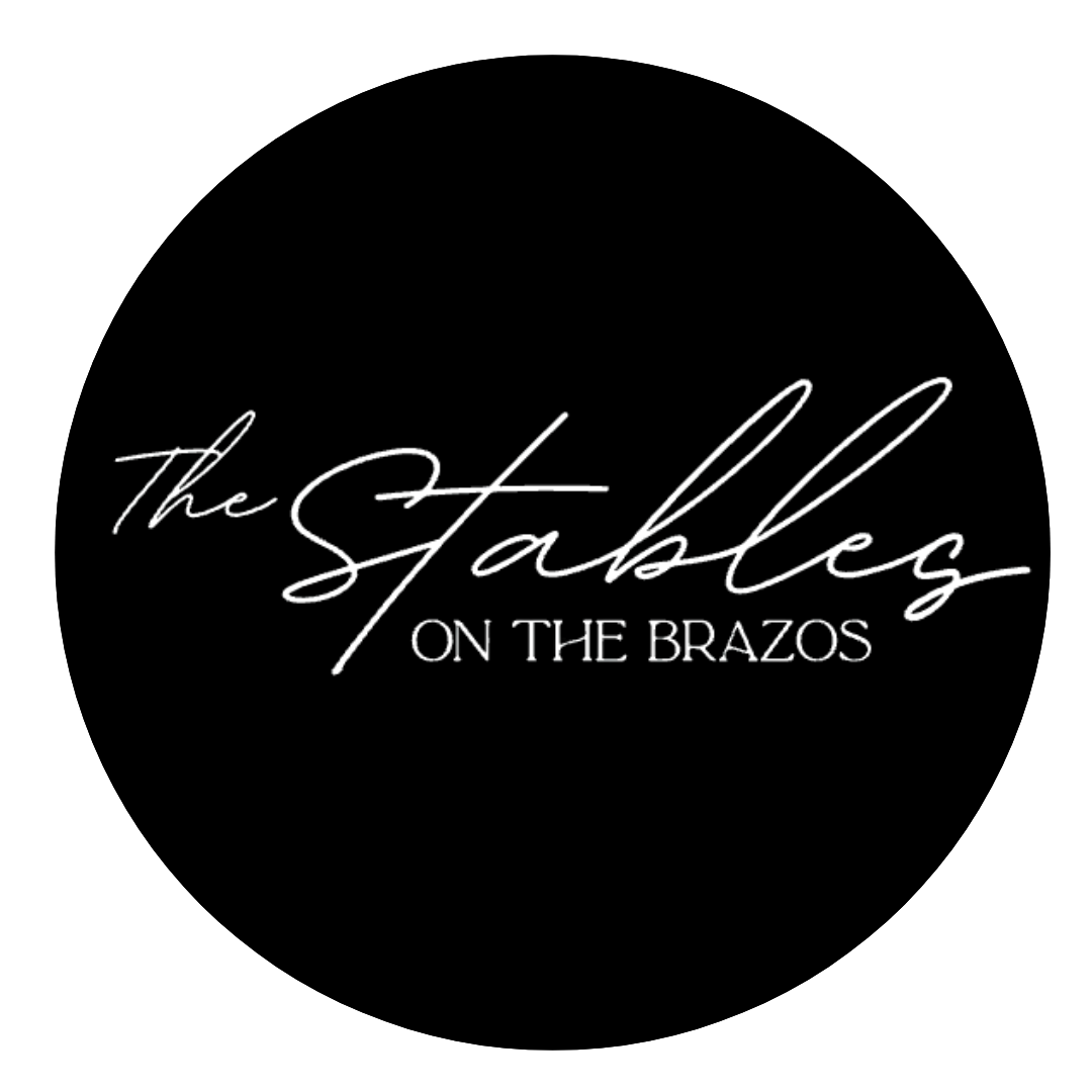 Black circular logo with white cursive text reading 'The Stablez ON THE BRAZOS'.