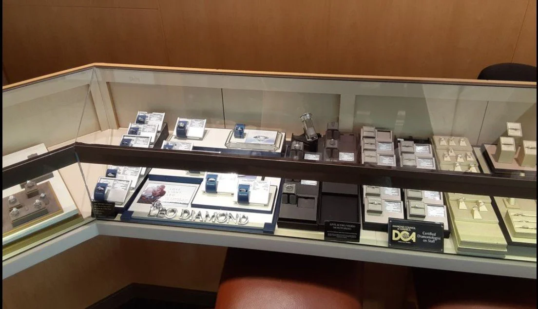 Jewelry display case featuring rings, watches, and other accessories in a jewelry store. New glass case top. jewelry case glass replacement. glass case repair. jewelry case repair