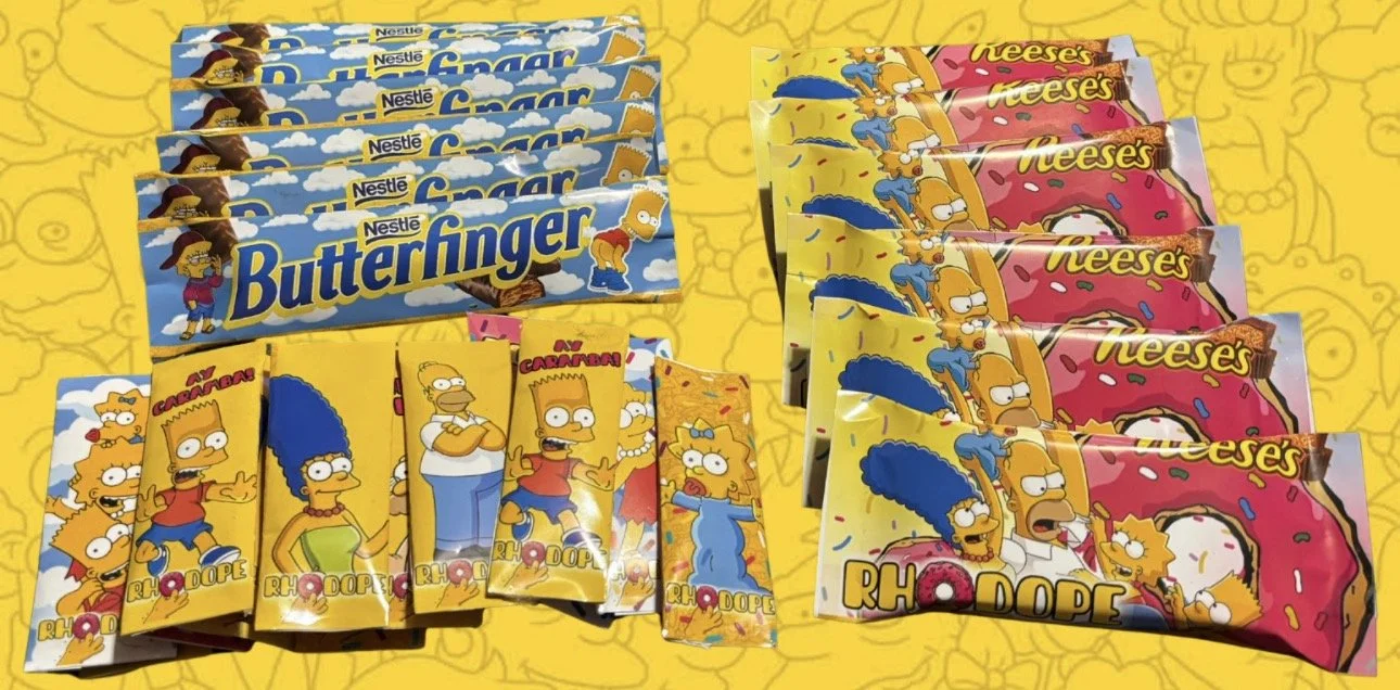Various candy bars featuring characters from The Simpsons, including Butterfinger, Reese's, and RhoDope, displayed on a yellow background with cartoon drawings.