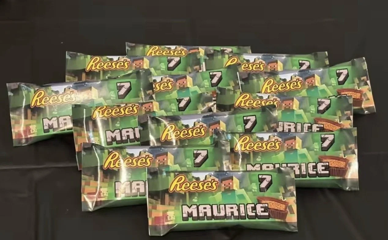 Multiple Minecraft-themed reese's snack packs on a table with a black surface.