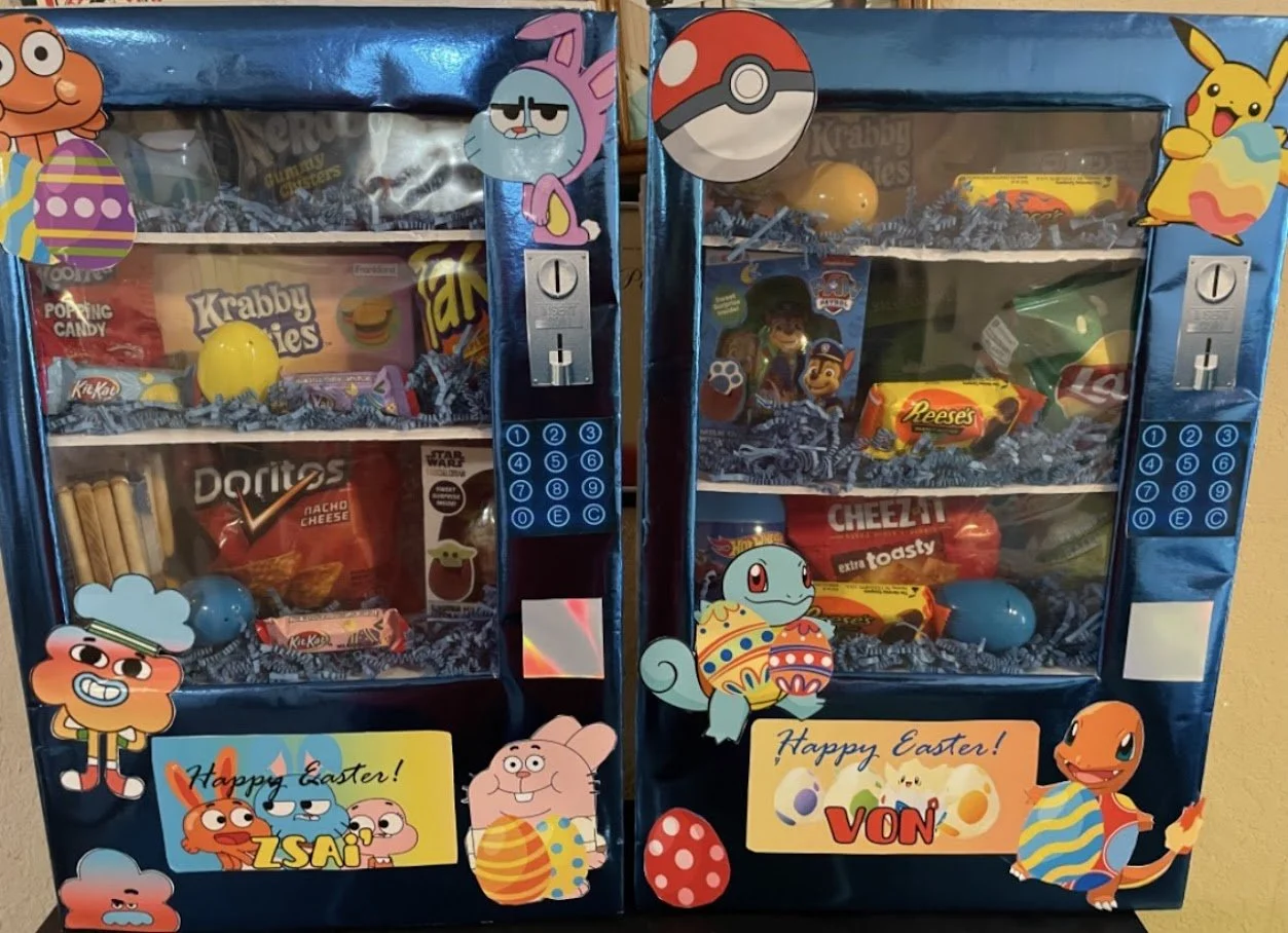 Two Easter-themed vending machines filled with snacks and candies, decorated with cartoon characters from animated series, including Pokémon, Paw Patrol, and other animated characters, with festive Easter eggs and signs that say 'Happy Easter!'
