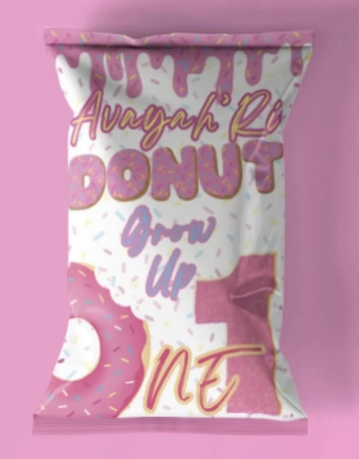 Colorful candy bag with pink and white donut illustration, surrounded by sprinkles. The text reads 'Avayah R. BONUS Grow Up 1 NE' in playful fonts.