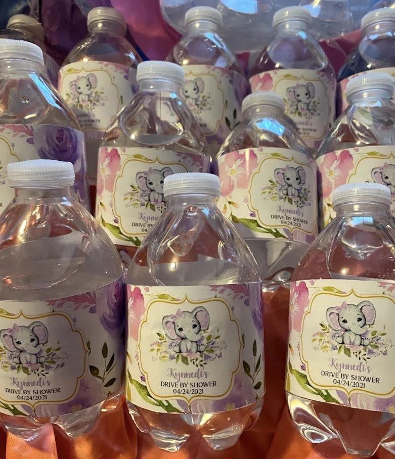 Bottles of water with labels featuring a cute cartoon koala sitting on flowers and the text 'Kynedi's Drive by Shower 04/24/2021'.