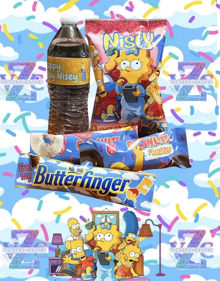 A collection of snacks and drinks featuring characters from The Simpsons on a colorful, cloud-filled background with rainbow sprinkles. Items include a plastic bottle labeled "Happy Nay Nisay I," a red bag of Nisy, a bar of Donuts Frosted, a pack of 