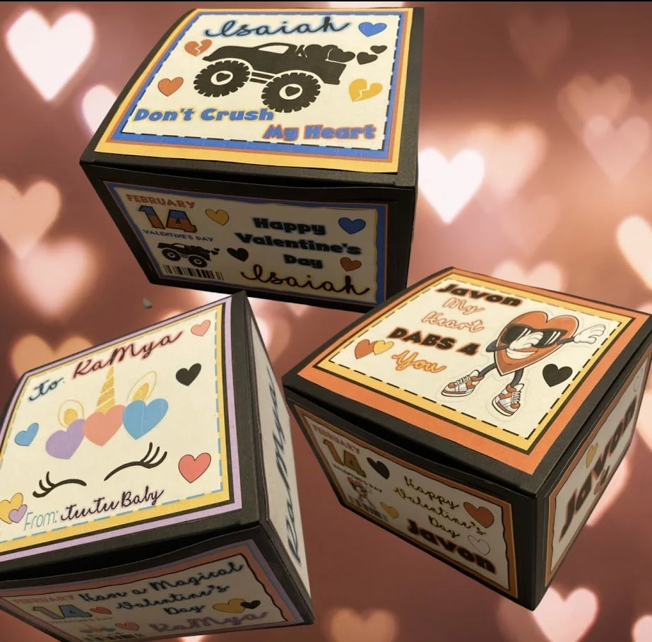 Three decorated gift boxes with colorful Valentine's Day and love-themed designs, one featuring the message "Isaiah, Don't Crush My Heart" and another with cartoon characters, hearts, and messages like "Happy Valentine's Day" and "To Kamya From Tutu 