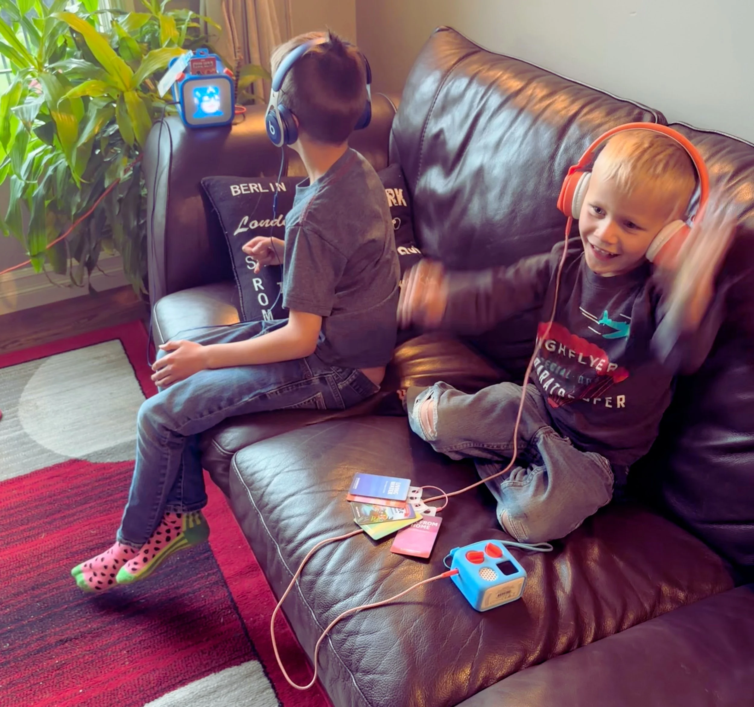 Two boys listening to their Yoto players at home