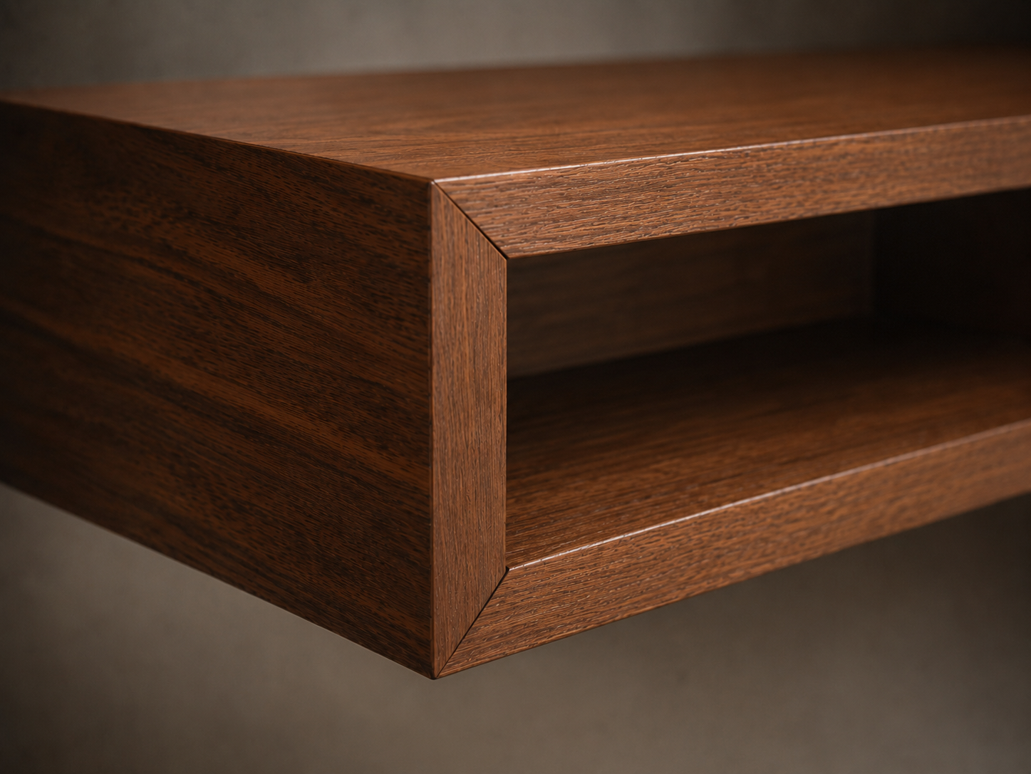 Close-up of a walnut shelf corner showing clean joinery and wood grain.