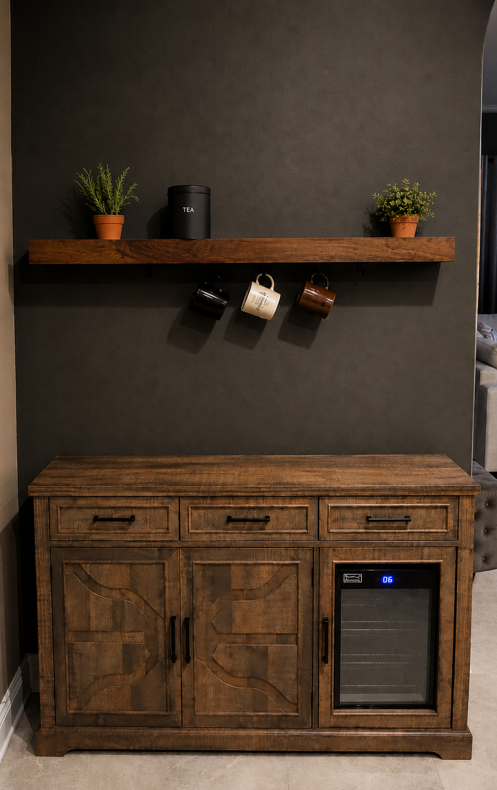 Custom beverage nook with storage cabinet, shelf, mugs, and tea canister.