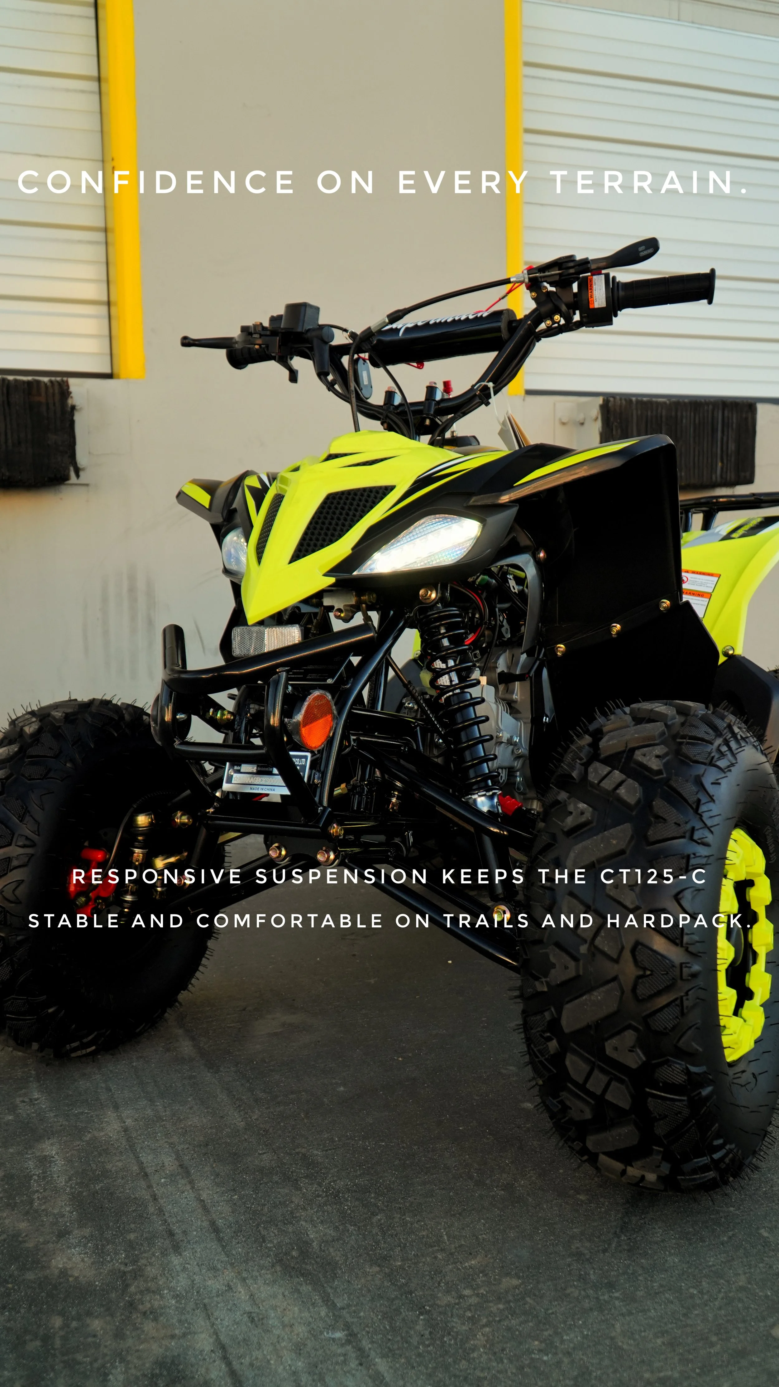 A bright yellow all-terrain vehicle (ATV) with large, rugged tires, displayed outdoors in front of a building with white siding and yellow trim, with promotional text overlaid.
