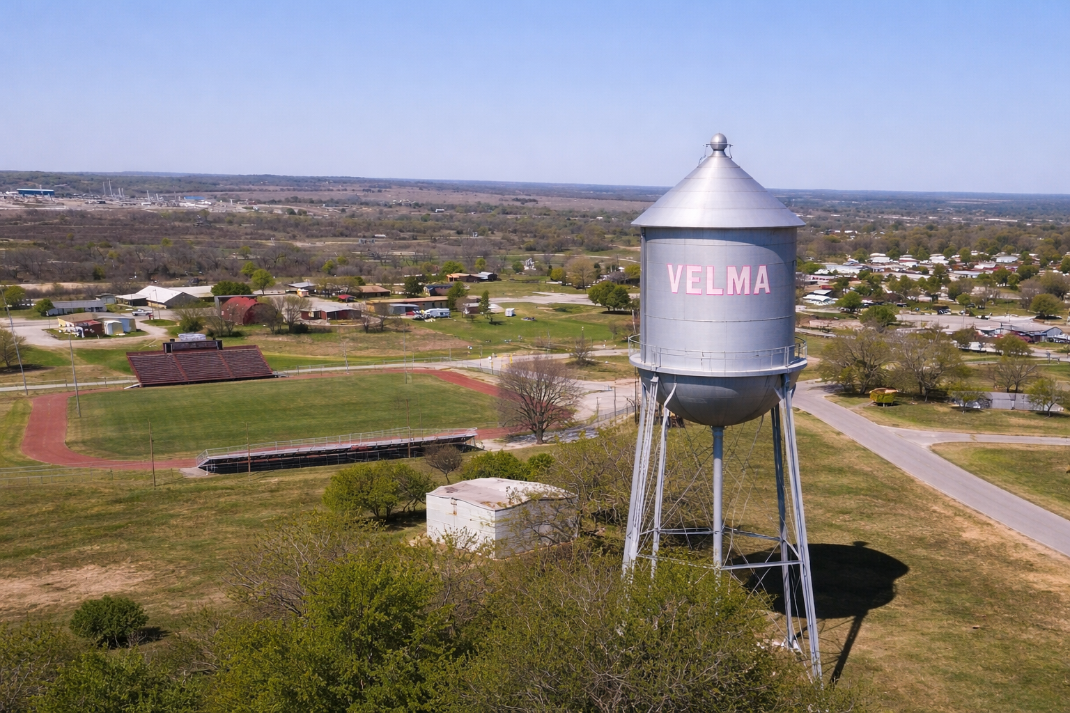 The Velma, Oklahoma water tower standing tall over the town. It’s the final landmark—the "home of the lessons and life" that anchors every story I tell through Hydrocarbon Wine Media.