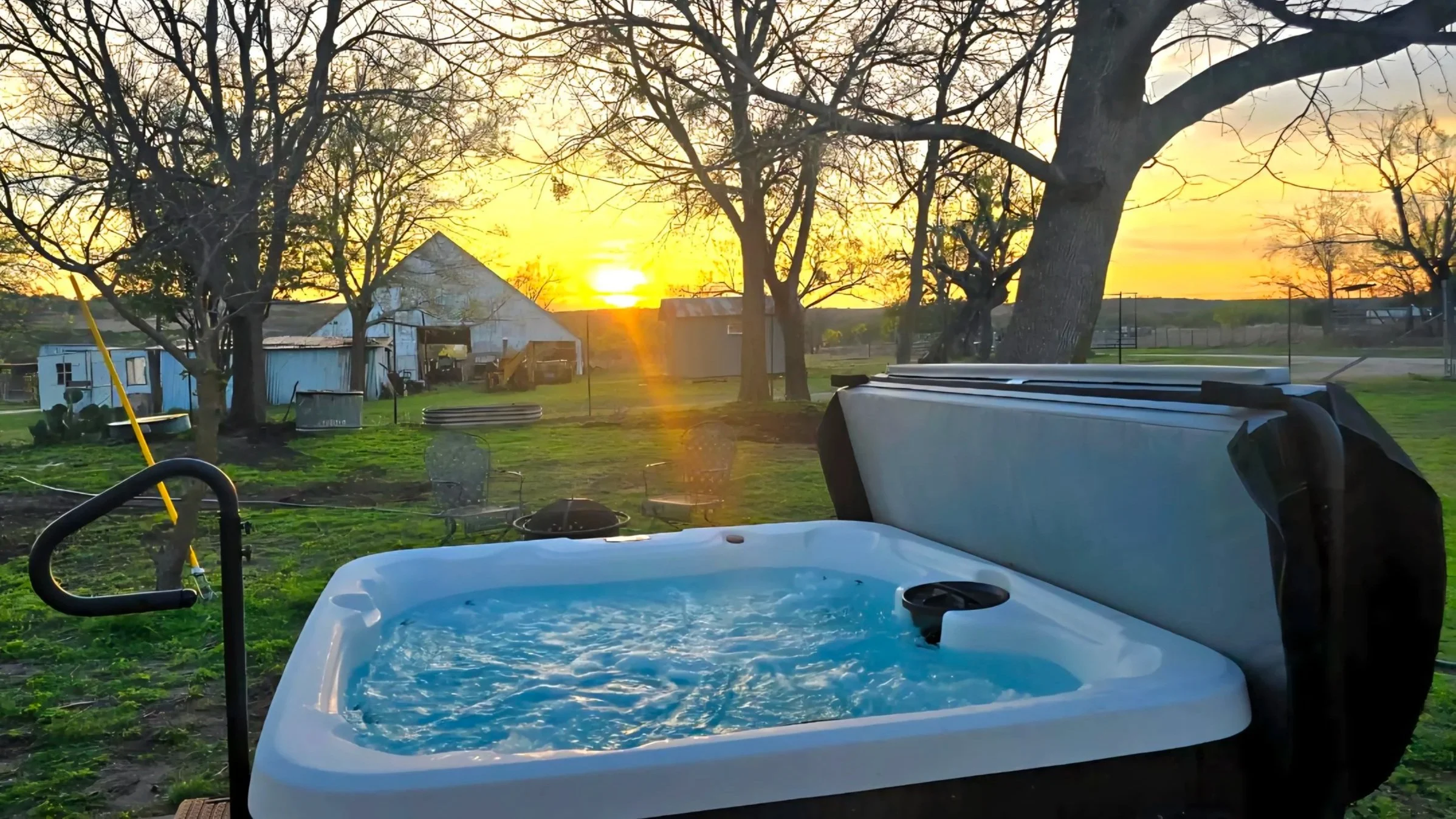 Kitchen with a black stove, white cabinets, and decorative rooster figurines on wall shelves.