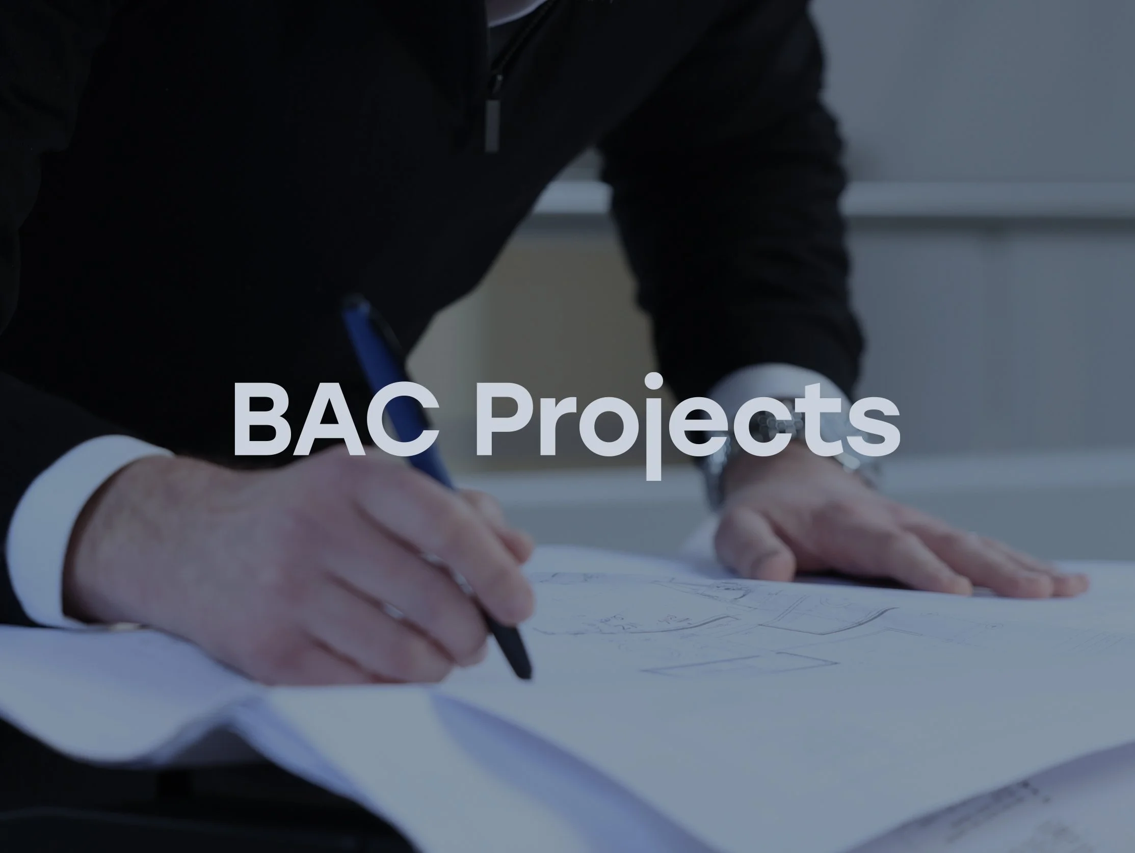 Person looking at building plans for BAC Projects