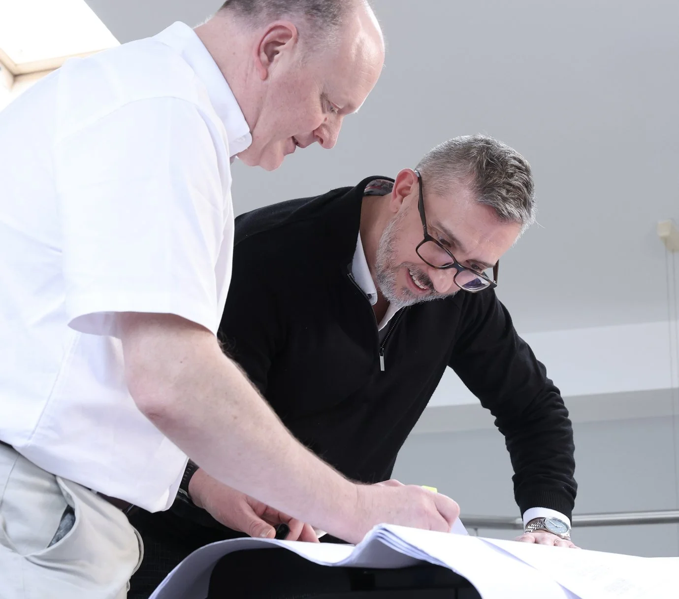 BAC team members looking at building plans for new automated systems