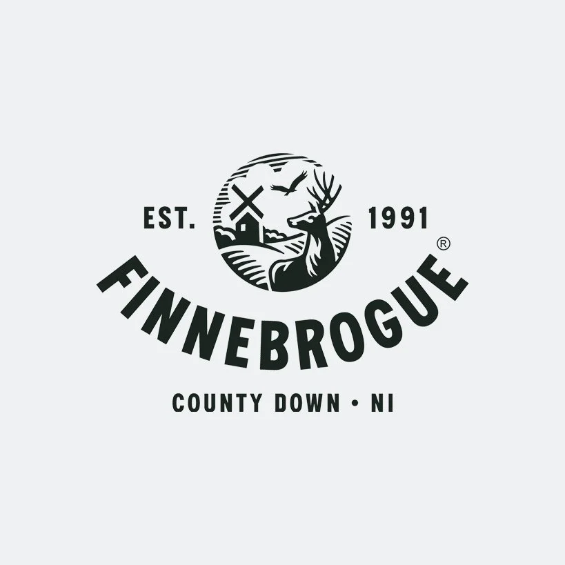 Logo for Finnebrogue, established in 1991, featuring a windmill, a deer, an eagle, and a rural landscape, located in County Down, Northern Ireland.