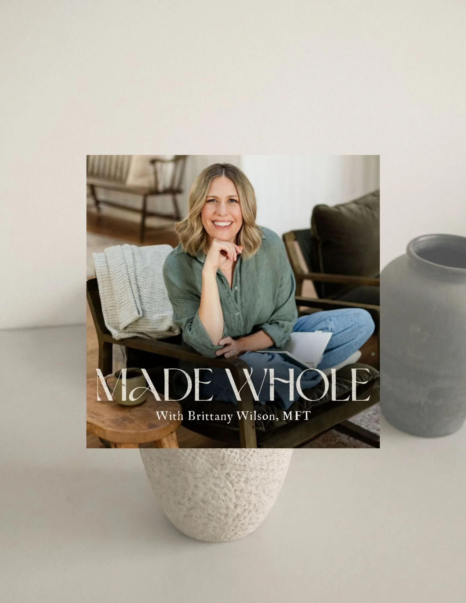 Cover of a podcast titled "MADE WHOLE" with Brittany Wilson, MFT, featuring a woman smiling and sitting on a couch in a cozy living room.