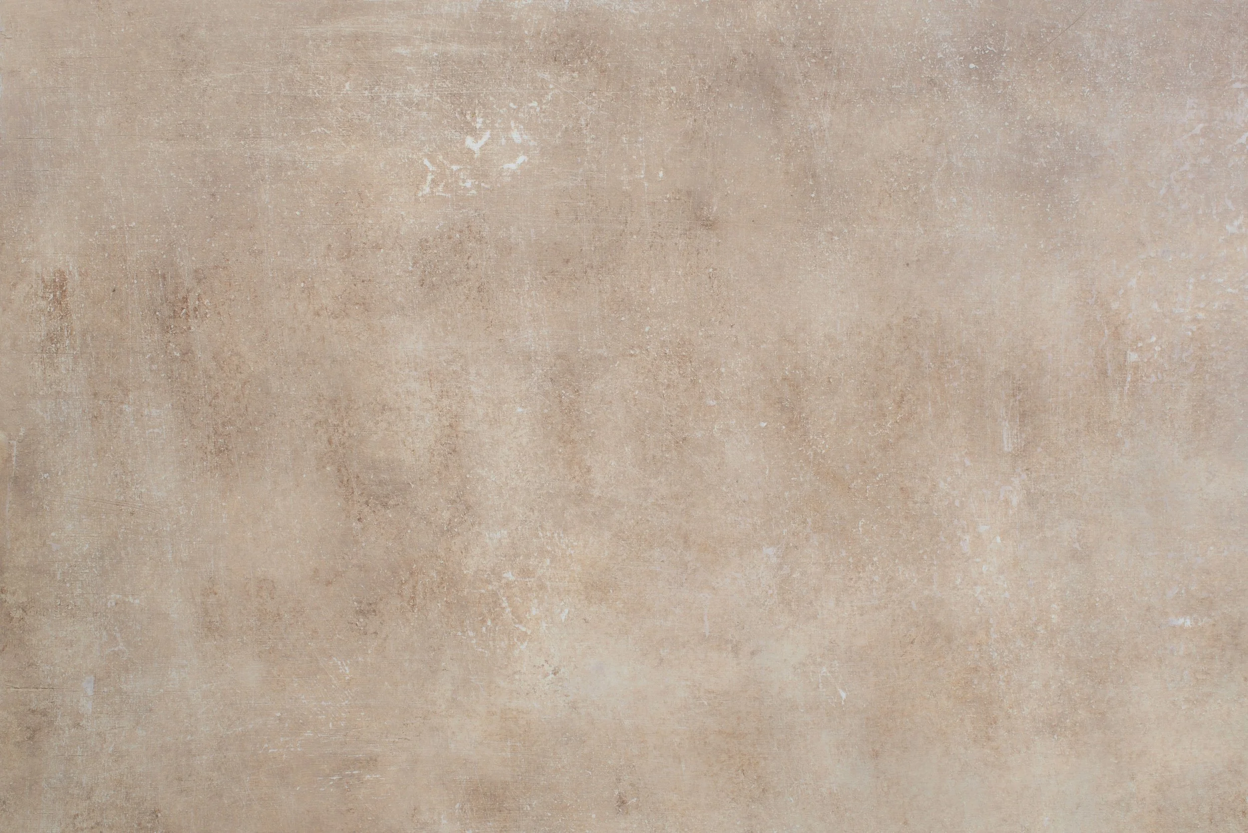 A close-up view of a textured beige and light brown wall surface.
