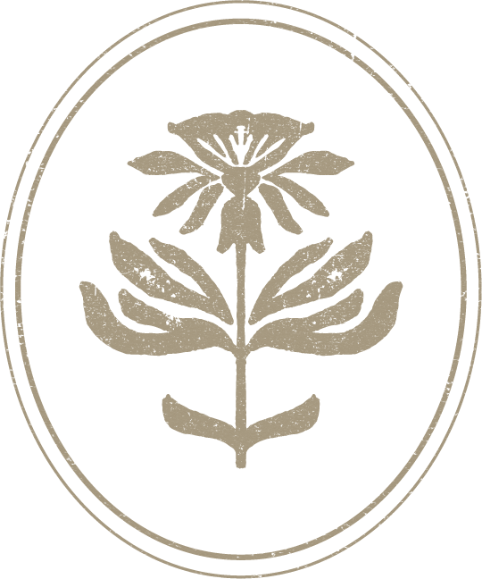 A beige floral emblem with a rose, leaves, and a stem inside an oval border on a black background.