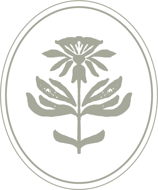 Black and white logo featuring a stylized flower with six petals and a bee at the center, enclosed within an oval border.