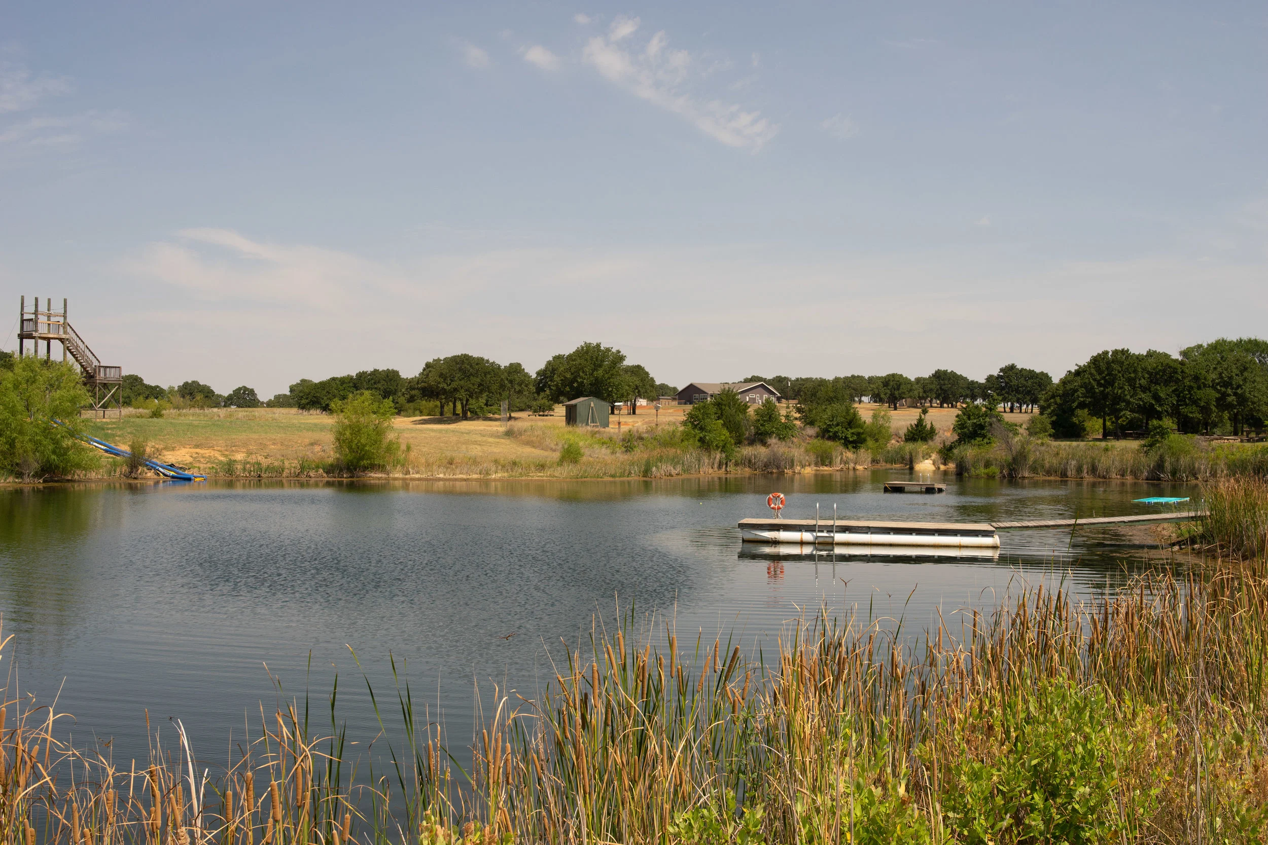 Peaceful lake with dock and distant countryside
